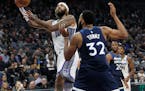 Kings center Willie Cauley-Stein gets around Timberwolves center Karl-Anthony Towns for a shot during the second half Friday.