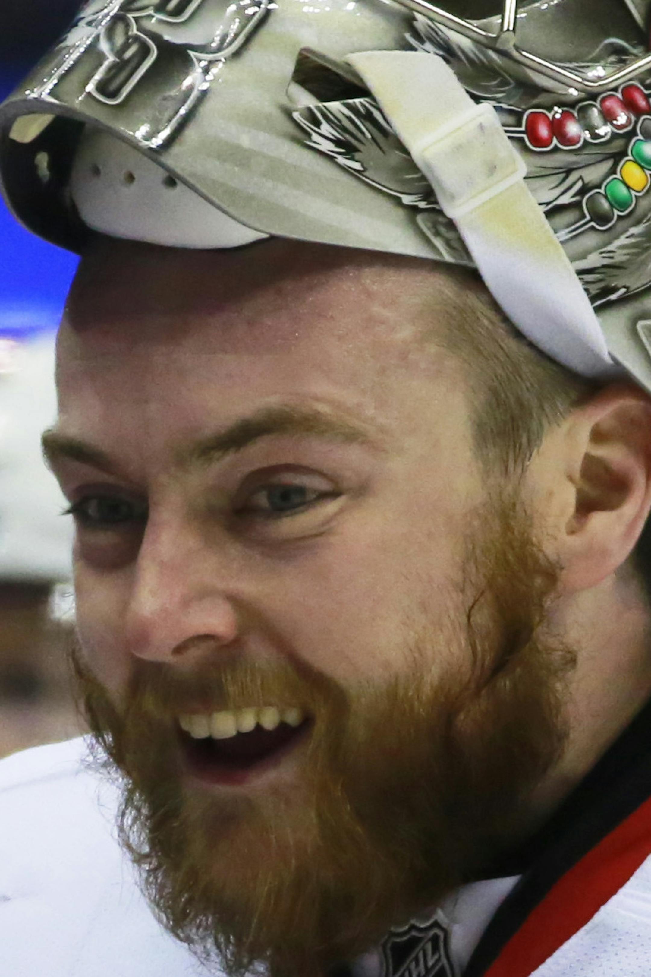 Chicago Blackhawks goalie Scott Darling smiles at the bench during the first period of an NHL hockey game against the Colorado Avalanche Saturday, April 11, 2015, in Denver. (AP Photo/Jack Dempsey) ORG XMIT: COJD103