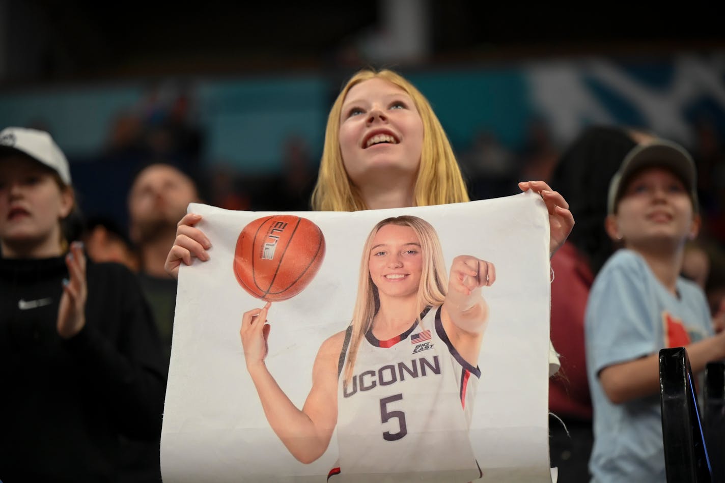 Olivia Hammer, 12, of New Ulm, holds up a poster of UConn guard Paige Bueckers (5) during a Final Four open practice held Saturday, April 2, 2022 at Target Center in Minneapolis, Minn.