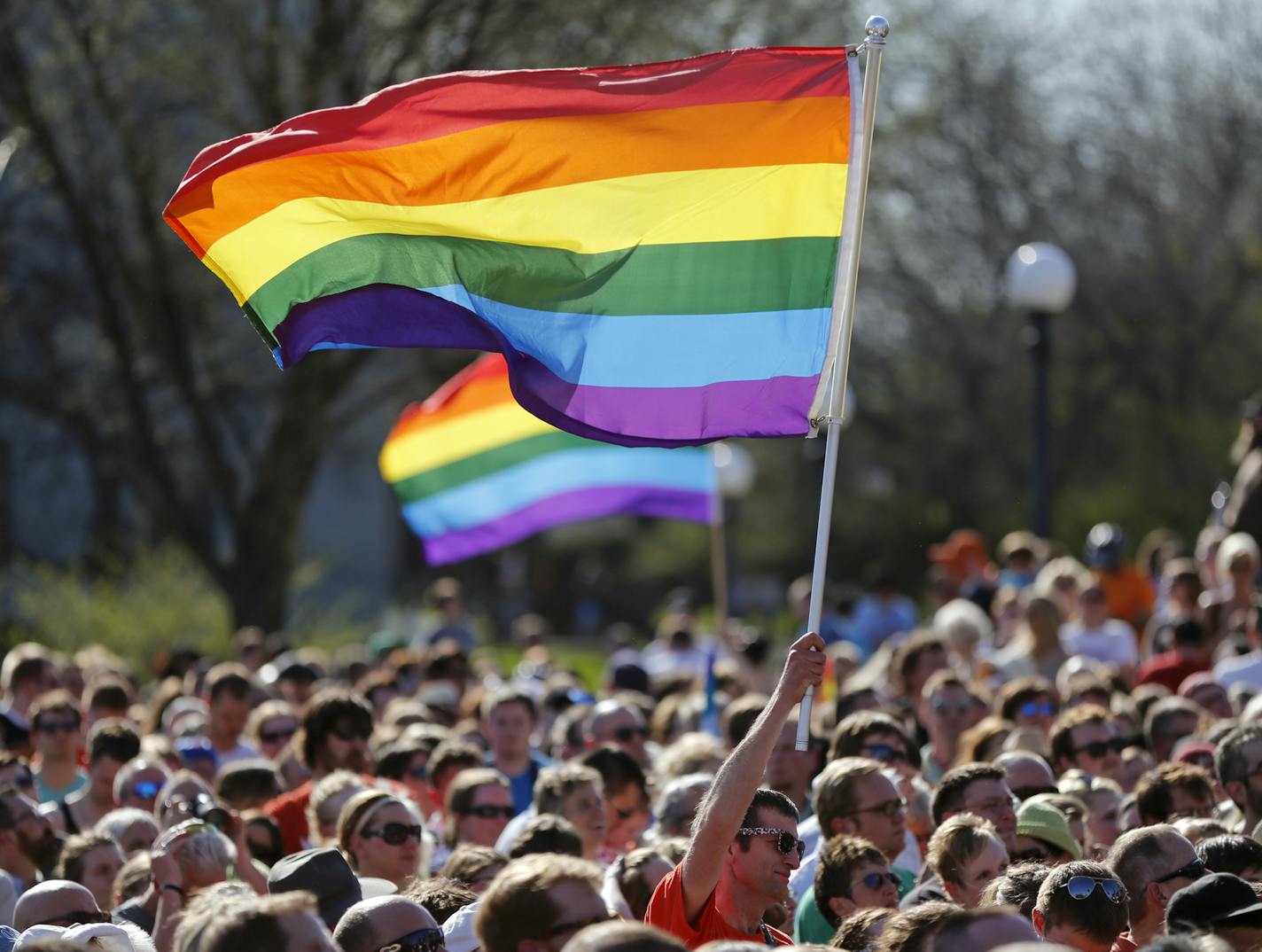 At the State Capitol Governor Mark Dayton signed the gay marriage bill into law in front of several thousand supporters .]rtsong-taatarii@startribune.com