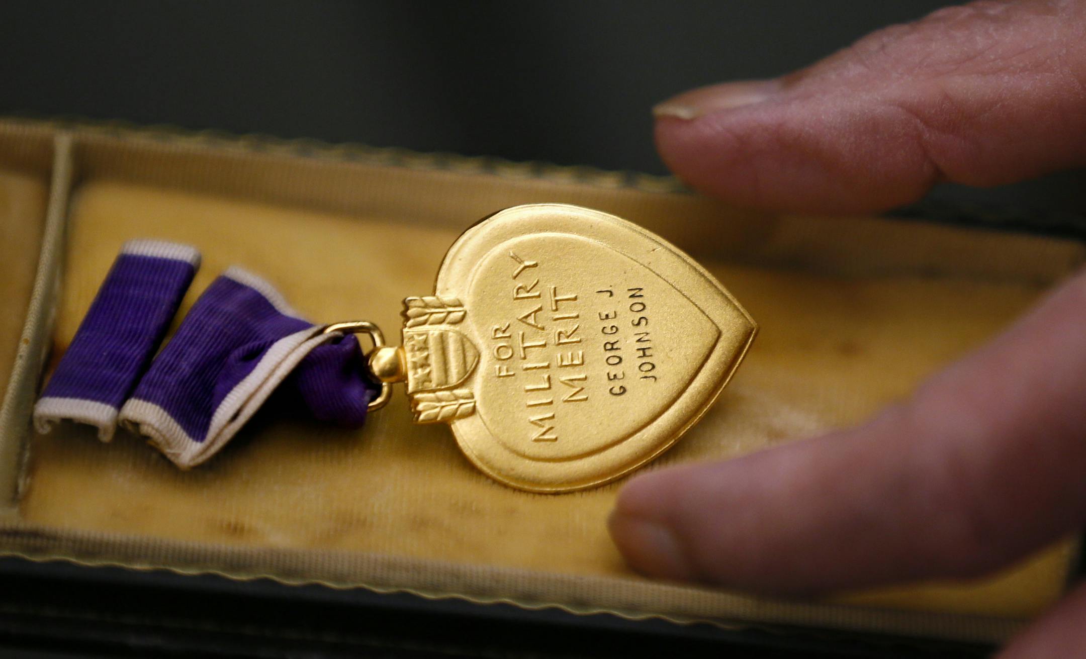 Minnesota Department of veterans Affairs Commissioner Larry Shellito left hugged William Johnson after giving him back the purple heart medal that his deceased brother, Korean War Veteran George J. Johnson earned. Commissioner Shellito presented the medal to family members during a ceremony Wednesday January 29, 2014 in St. Paul ,MN.] George Johnson died July 28, 1950 in the Battle of Hwanggan, his parents were presented the with a Bronze Star, Medal and Purple Heart medal for his bravery . The