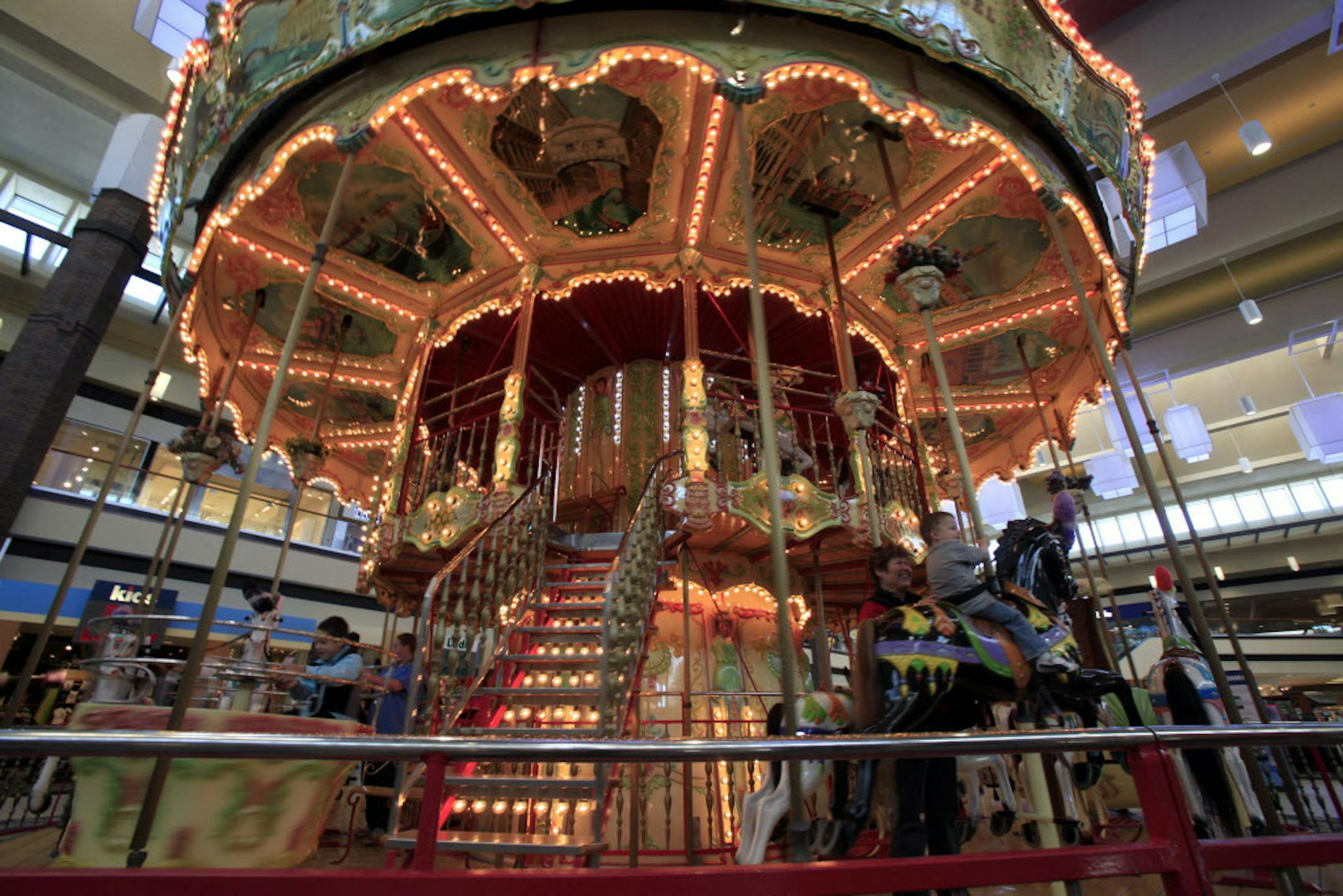 Yvonne Cadwallader takes her grandson Parker Cadwallader on the carousel at the renovated Maplewood Mall. The center court of Maplewood Mall was completely renovated including the carousel. ] JOEL KOYAMA‚Ä¢joel.koyama@startribune.com Maplewood Mall, one of two in the Twin Cities owned by national mall giant Simon Property Group, has undergone a renovation which included new lighting, carpet and a fresh coat of paint. Across town, Southdale is facing a similar renovation by Simon