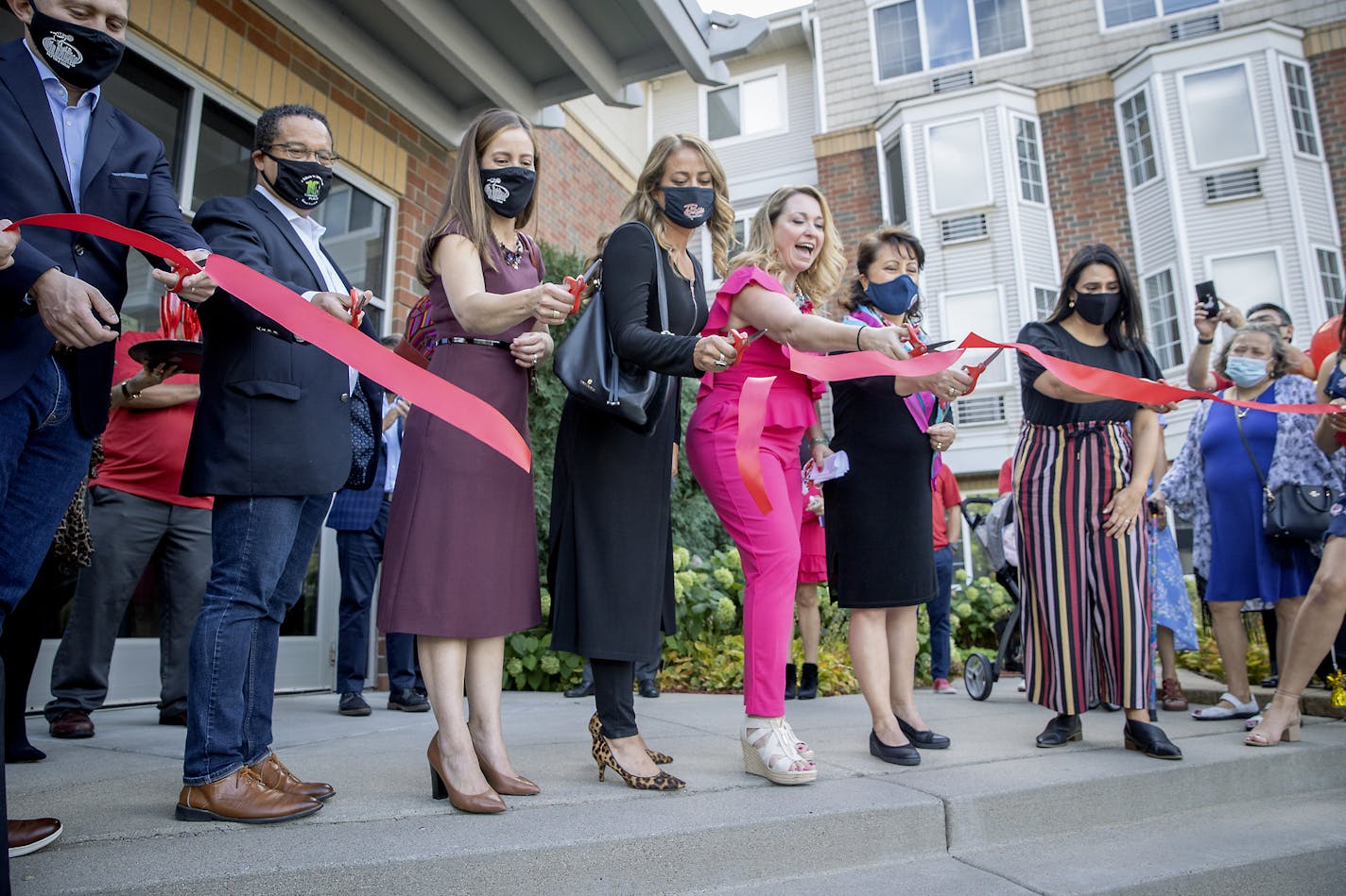 Maya Santamaria, center, was surrounded by local politicians to cut a ribbon to inauguarate La Raza's new studios in leased space, Wednesday, September 17, 2020 in Richfield, MN. The La Raza radio studios, burned out in May when the Oddfellows Building on E. Lake Street was gutted by arson during the riots. La Raza is Hennepin County's sole Spanish-language radio station. "We have gone through a lot in the last three months," said CEO Maya Santamaria of parent-company Santamaria Broadcasting. "K