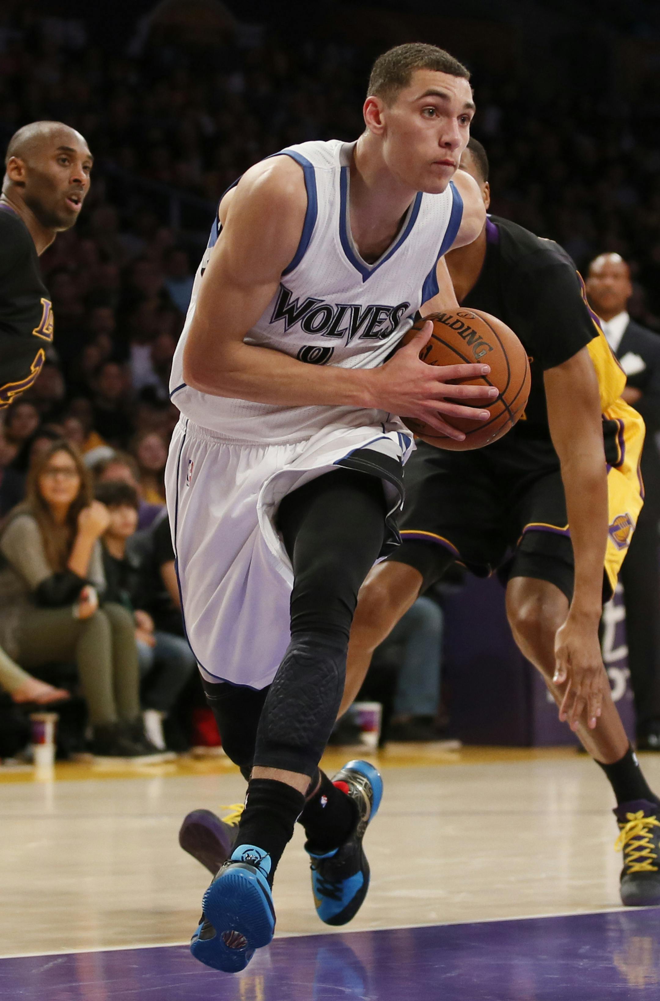 Minnesota Timberwolves' Zach LaVine takes the ball past Los Angeles Lakers' Wesley Johnson during the first half of an NBA basketball game Friday, Nov. 28, 2014, in Los Angeles. (AP Photo/Danny Moloshok)
