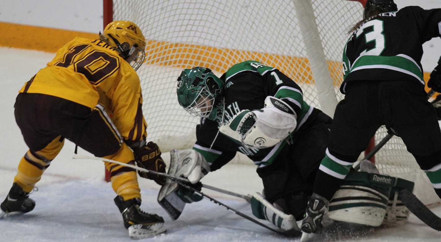 Gopher vs. North Dakota, Ridder Arena, 3/16/13. (left to right) Gophers Kelly Terry scored the winning goal on North Dakota goalie Shelby Amsley-Benzie, in the 3rd overtime.] Bruce Bisping/Star Tribune bbisping@startribune.com Kelly Terry, Sahelby Amsley-Benzie/roster. CORRECTED CAPITON ORG XMIT: MIN1303162128050801