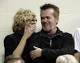 FILE - In this Dec. 31, 2011 file photo, Actress Meg Ryan, left, talks with performer John Mellencamp during the second half of an NCAA college basket