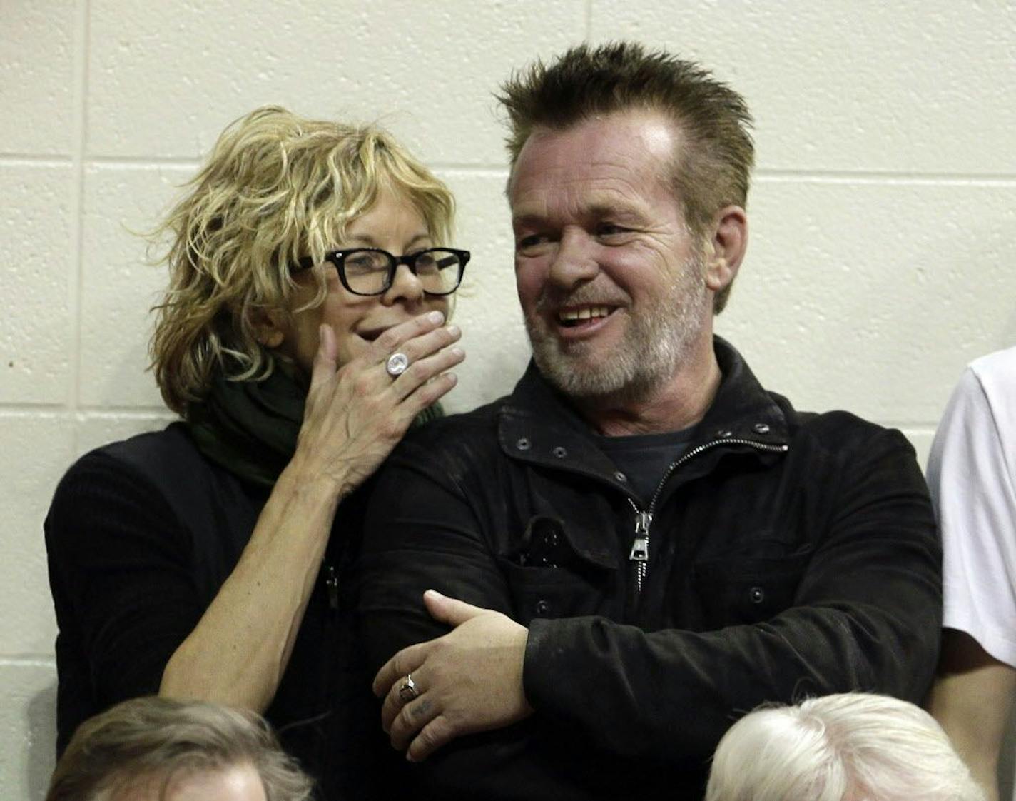 FILE - In this Dec. 31, 2011 file photo, Actress Meg Ryan, left, talks with performer John Mellencamp during the second half of an NCAA college basketball game between Indiana and Ohio State in Bloomington, Ind. Mellencamp and Ryan are getting married. Ryan announced her engagement on Instagram. "ENGAGED!," is what she wrote. The post included a drawing of what appears to be the two holding hands. He's also holding a guitar.