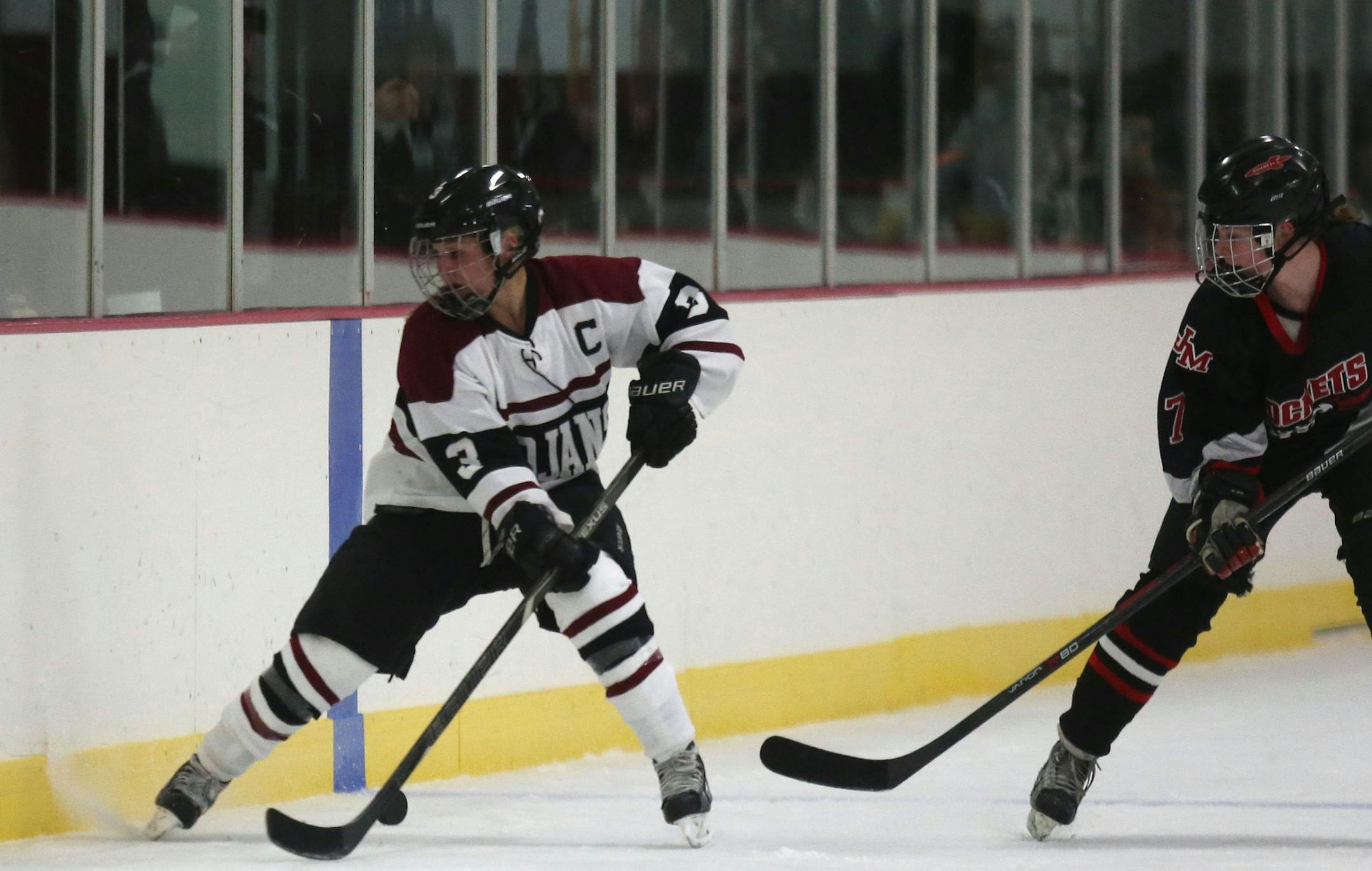 New Prague's Marissa Shimota tried to settle the puck with Rochester John Marshall defending. ] (KYNDELL HARKNESS/STAR TRIBUNE) kyndell.harkness@startribune.com Girls hockey New Prague vs Rochester John Marshall in New Prague , Min., Thursday, November 13, 2014.