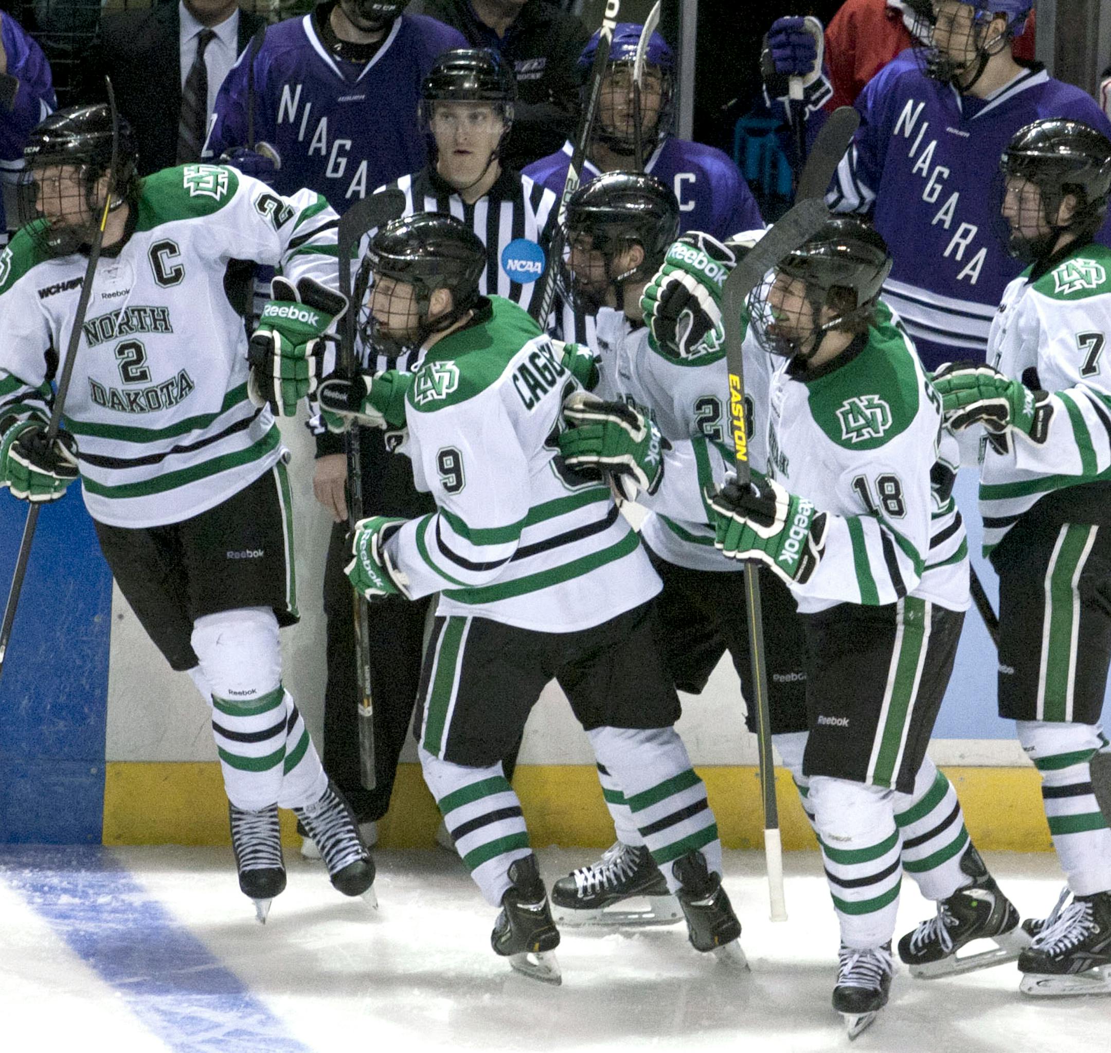 North Dakota players celebrates after scoring against Niagara during an NCAA college hockey regional tournament game in Grand Rapids, Mich., Friday, March 29, 2013. North Dakota defeated Niagara 2-1. (AP Photo/The Grand Rapids Press, Latara Appleby) ALL LOCAL TV OUT; LOCAL TV INTERNET OUT.