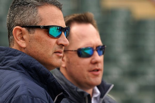 The Twins' Thad Levine (left) and Derek Falvey are still working on deals to possibly add a starter and/or a reliever before the trade deadline.