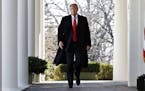 President Donald Trump walks through the Colonnade from the Oval Office of the White House as he arrives to announce a deal to temporarily reopen the 