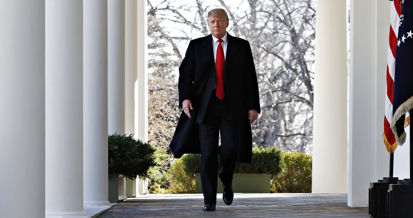 President Donald Trump walks through the Colonnade from the Oval Office of the White House as he arrives to announce a deal to temporarily reopen the government, Friday, Jan. 25, 2019, from the Rose Garden of the White House in Washington. (AP Photo/Jacquelyn Martin)