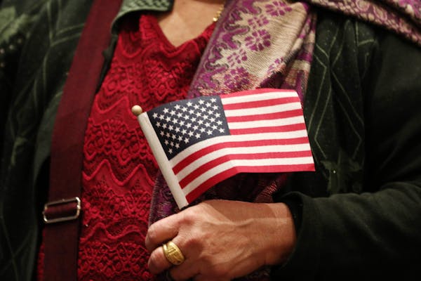 Hla Tun, who was from Burma, held an American flag during a recent naturalization ceremony.