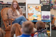Student teacher Caitlin Efta asks students in Elise Campbell’s first grade class about their weekend at the start of their class on Monday at Lester