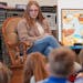 Student teacher Caitlin Efta asks students in Elise Campbell’s first grade class about their weekend at the start of their class on Monday at Lester