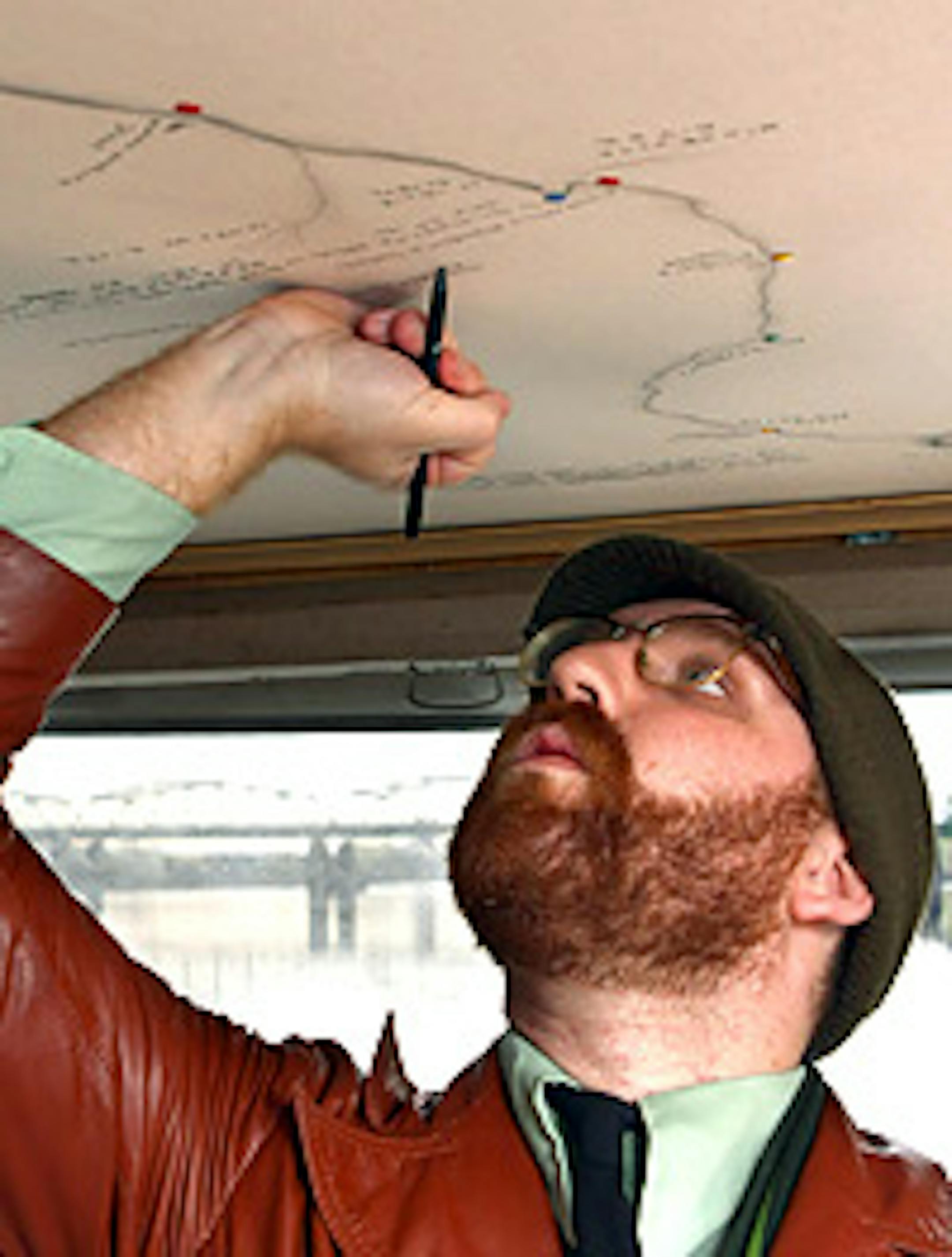 Eli Anthony works on the ceiling map of the Mississippi River.