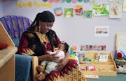 Irene Ford, 68, of Minneapolis, spends time with infants as one of the foster grandparent volunteers at the Catholic Charities Northside Child Develop