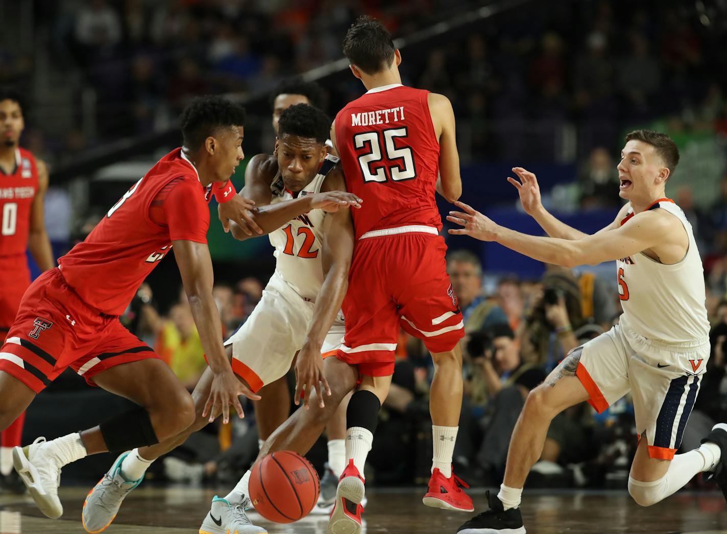 Texas Tech guard Jarrett Culver (23) drove around Virginia guard De'Andre Hunter (12)