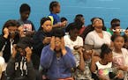Kids at the Jerry Gamble Boys & Girls Club in Minneapolis test out certified solar eclipse glasses they received from UnitedHealthcare on Wednesday. (