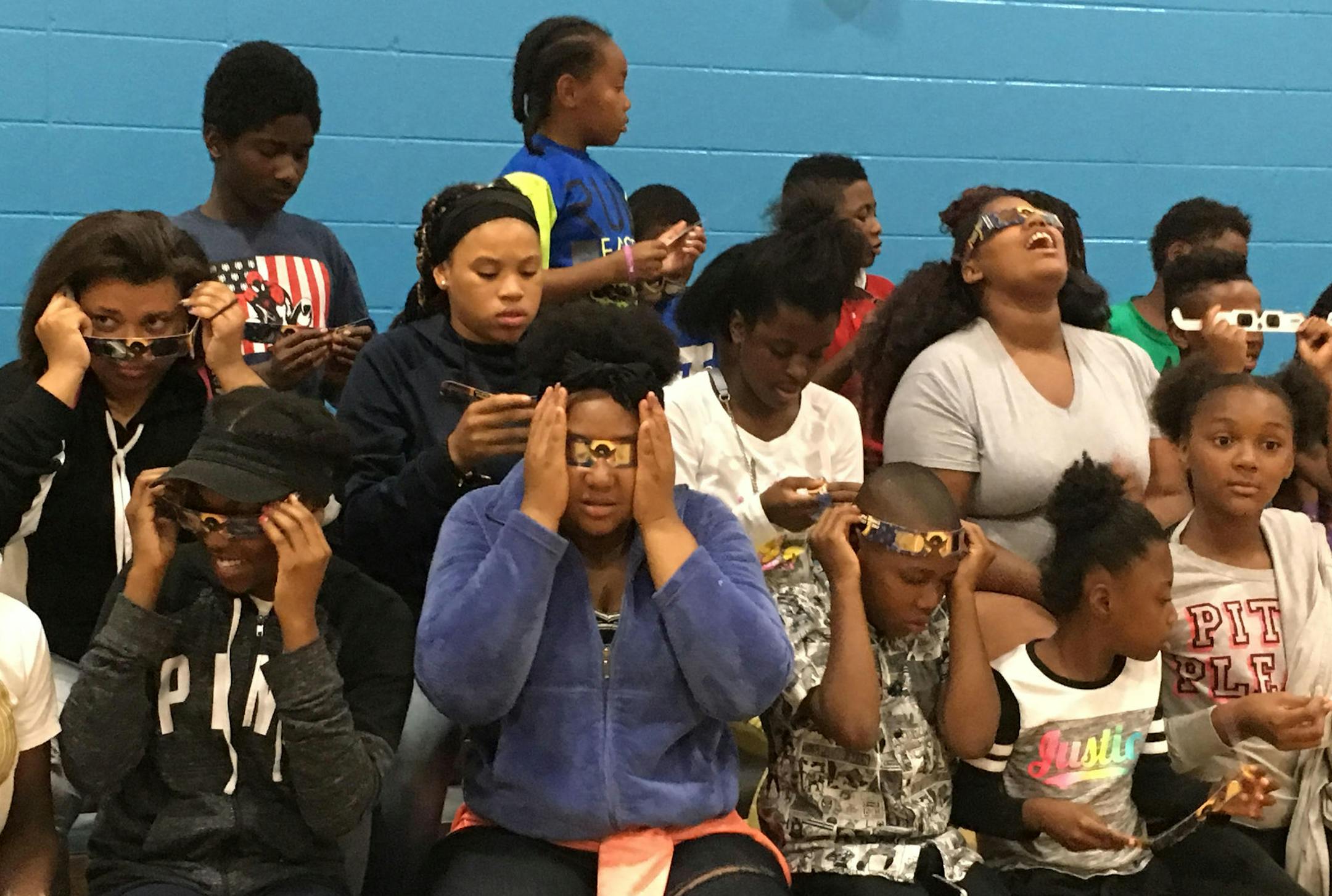Kids at the Jerry Gamble Boys & Girls Club in Minneapolis test out certified solar eclipse glasses they received from UnitedHealthcare on Wednesday. (Sarah Jarvis, Star Tribune)