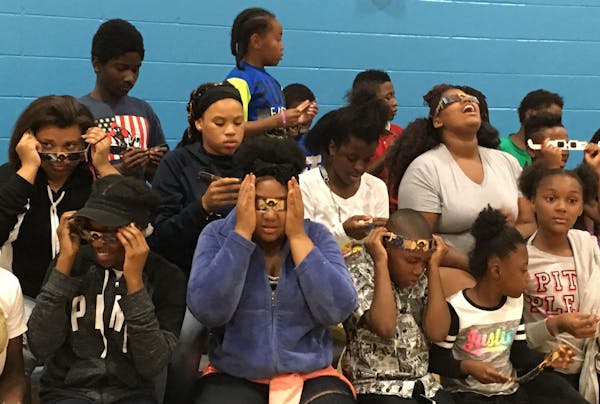 Kids at the Jerry Gamble Boys & Girls Club in Minneapolis test out certified solar eclipse glasses they received from UnitedHealthcare on Wednesday. (