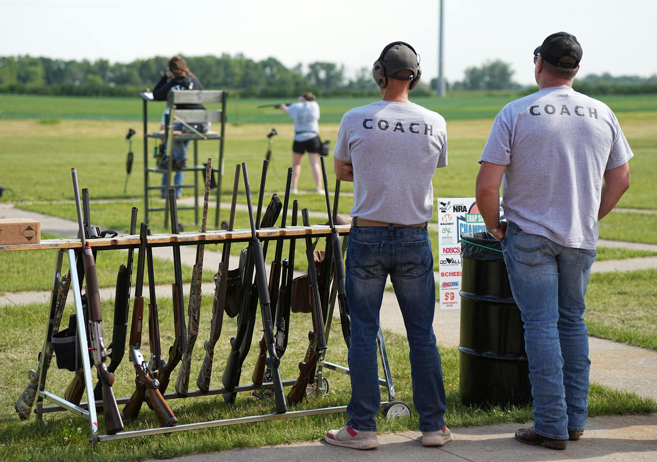 Coaches watch during the Minnesota State High School Trap Shooting Championships.