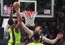 Brooklyn Nets center Tyler Zeller (44) fouls Minnesota Timberwolves guard Jimmy Butler (23) in the first quarter of an NBA basketball game Saturday, J