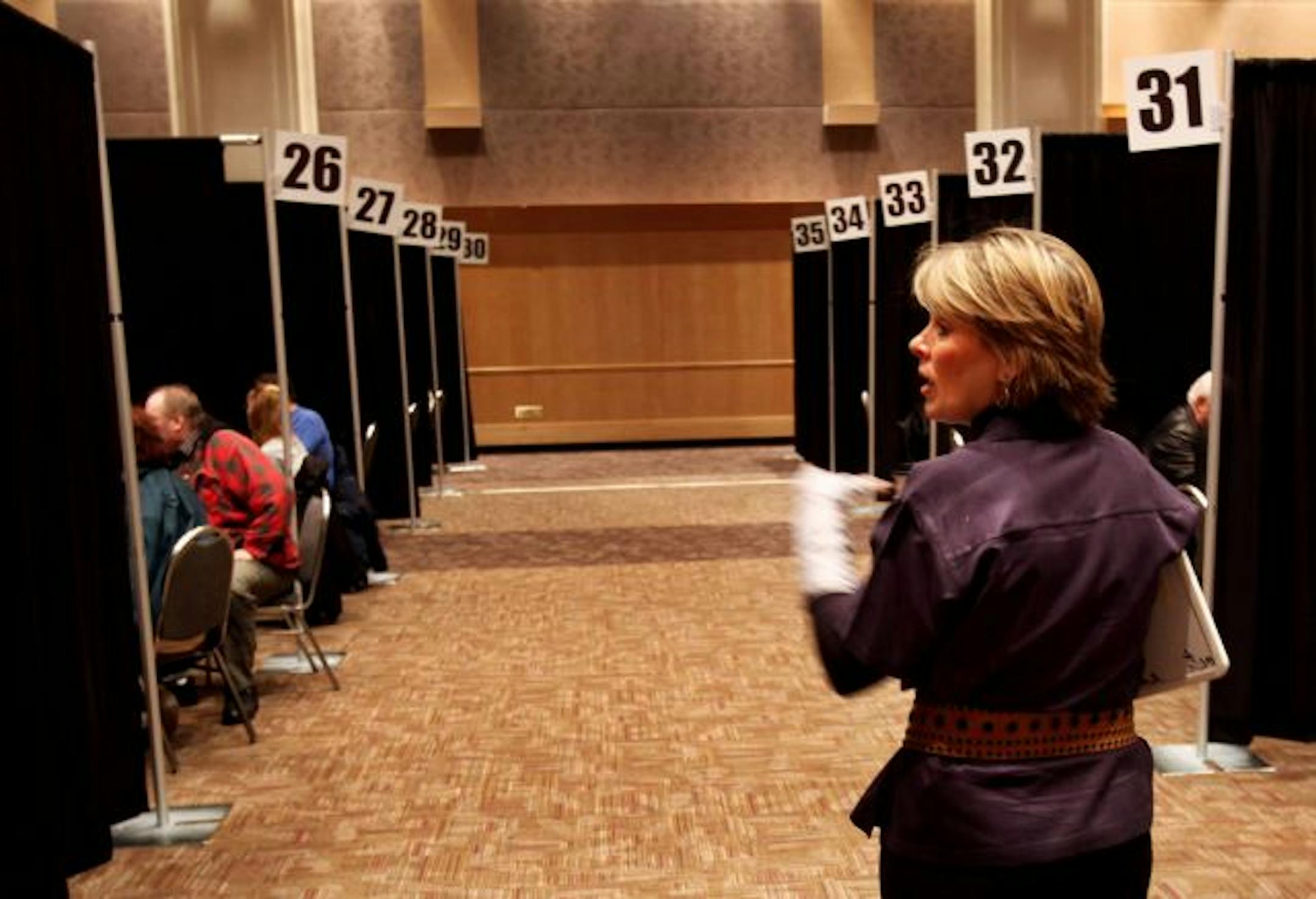 Sherry Schafer of Wells Fargo & Co. directed homeowners to booths at the RiverCentre in St. Paul where they met face to face with loan modification specialists. The bank was helping homeowners with delinquent mortgages and other financial challenges try to renegotiate their loans.