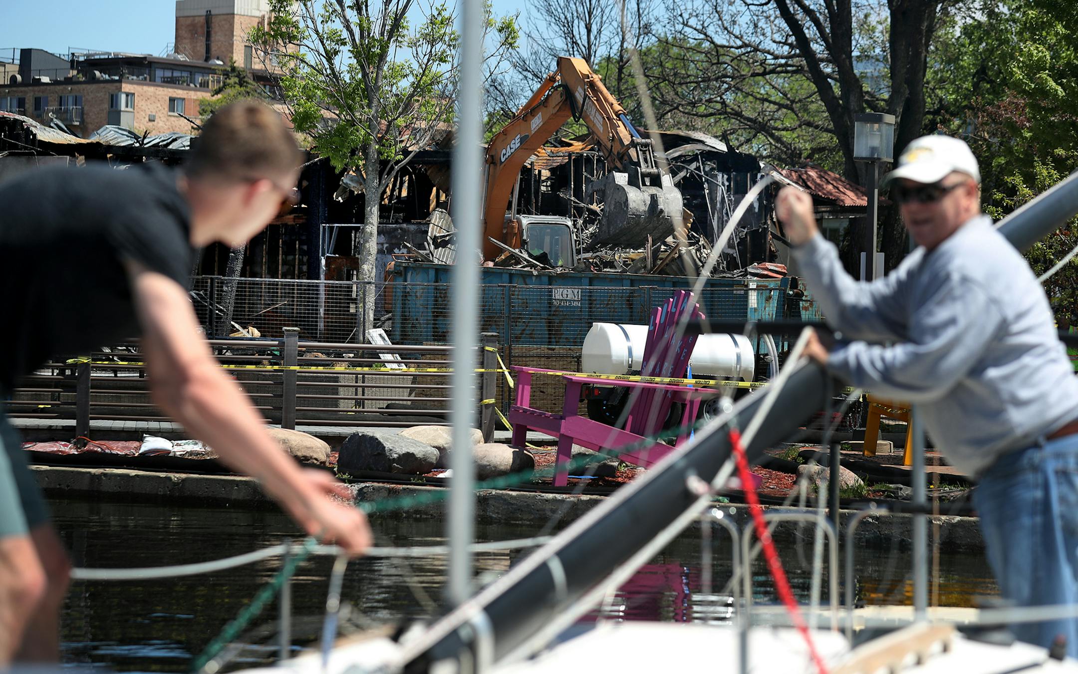 Fran Fagerstrom, right, prepares to launch his 23 foot sailboat with the help of his son Erik as an excavator tears down the remnants of Lola on the Lake at the pavilion at Bde Maka Ska/Lake Calhoun, damaged beyond repair during a recent fire and seen Tuesday, May 28, 2019, in Minneapolis, MN.] DAVID JOLES &#x2022; david.joles@startribune.com Minnehaha Creek is flooding near Penn Av. and 54th street, which has uprooted trees in some areas. The Minnehaha Creek Watershed District website said the