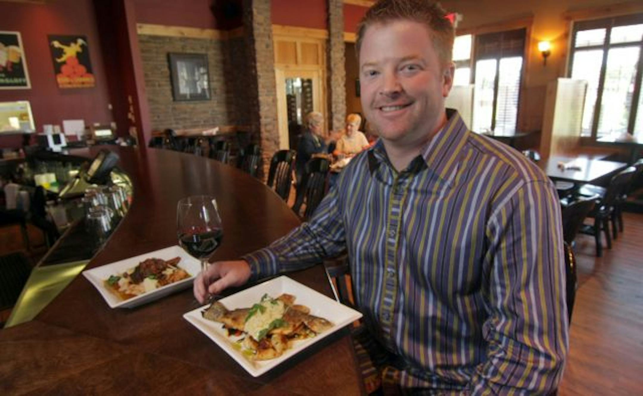 Owner Corey Burstad inside his T-Box Bar & Grill, with plates of rainbow trout and lamb shank. Both were sourced from the restaurant's adjacent market.