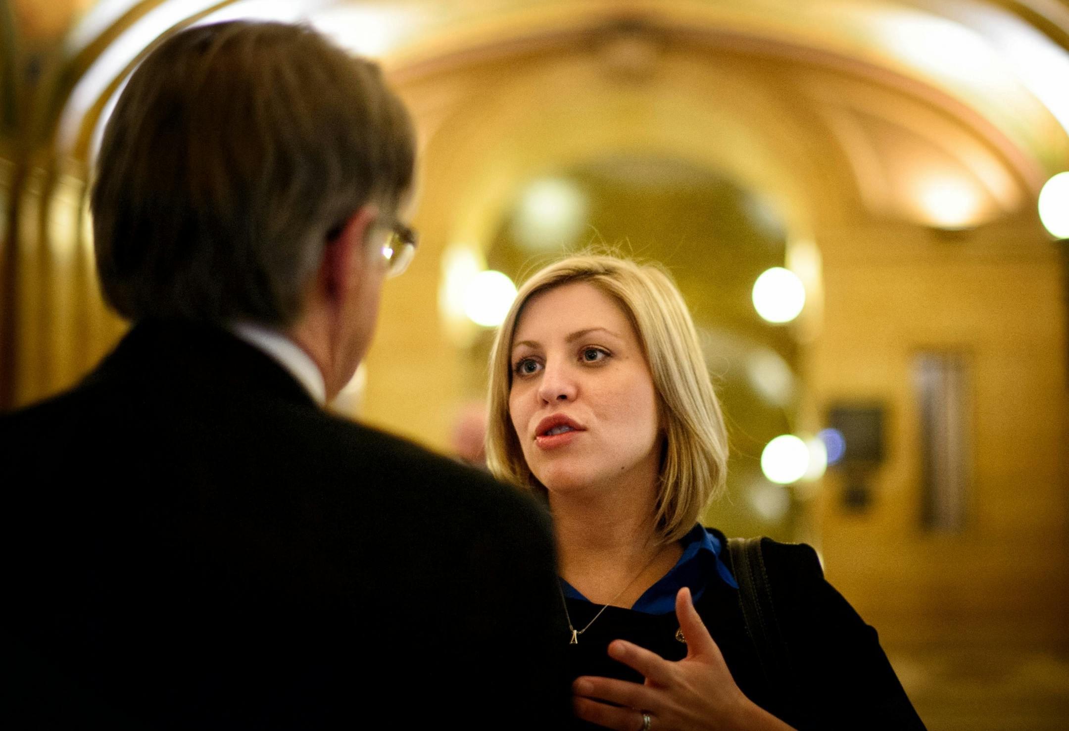 On her way to meet with Sen. Sandra Pappas office, Rep. Carly Melin paused to talk with Department of Labor and Industry Commissioner Ken Peterson about a provision of her Women's Economic Security Act.