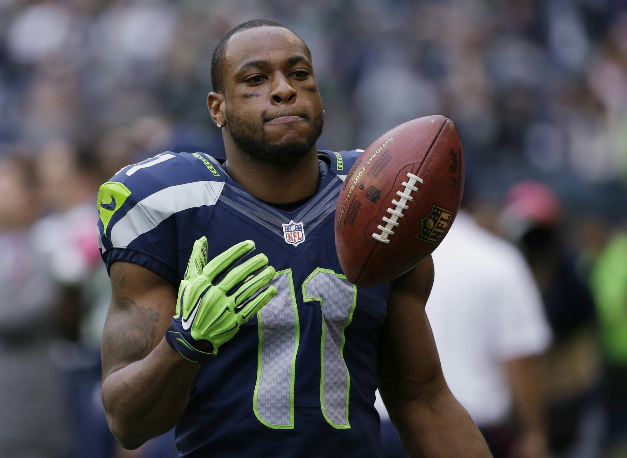 In this Oct. 12, 2014, photo, Seattle Seahawks wide receiver Percy Harvin stands on the sideline late in the second half of the Seahawks' 30-23 loss to the Dallas Cowboys in an NFL football game in Seattle. The New York Jets have acquired Harvin from the Seahawks. Two people familiar with the trade told The Associated Press on Friday, Oct. 17, 2014, that Harvin, a star in last season's Super Bowl but injury-prone through his career, was headed to the Jets. The people spoke anonymously because th