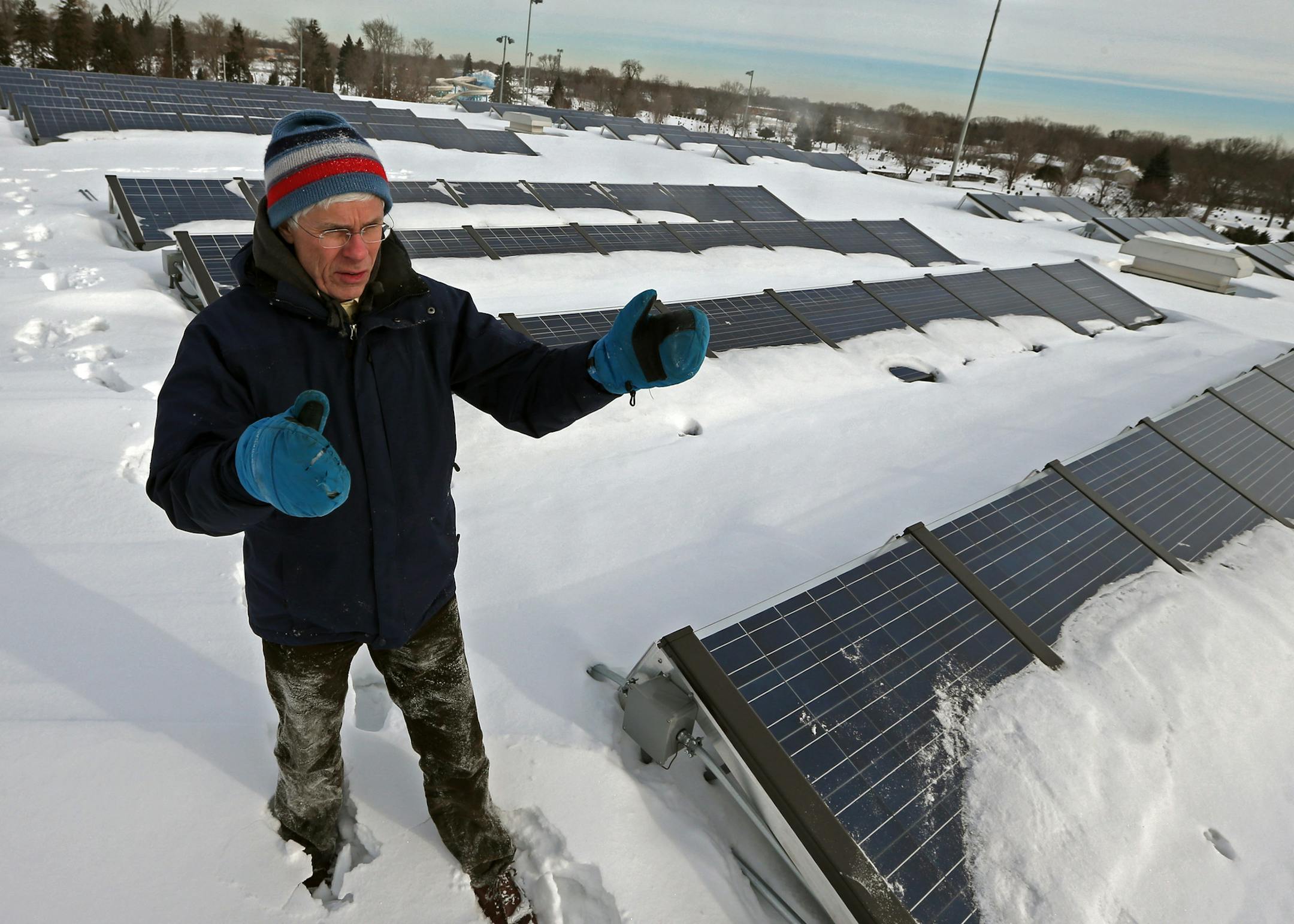 Thomas Mathisen, Crystal MN., City Engineer/Public Works Director, examined the solar cells installed on the roof of the Crystal Community Center on 1/21/14. Champlin has opted to join a growing number of metro cities that are putting solar energy collectors on city buildings in hopes of saving some money through subsidy programs and reducing reliance on fossil fuels. The city approved putting solar panels on its City Hall, public works, ice arena and public safety buildings. The deal with priva
