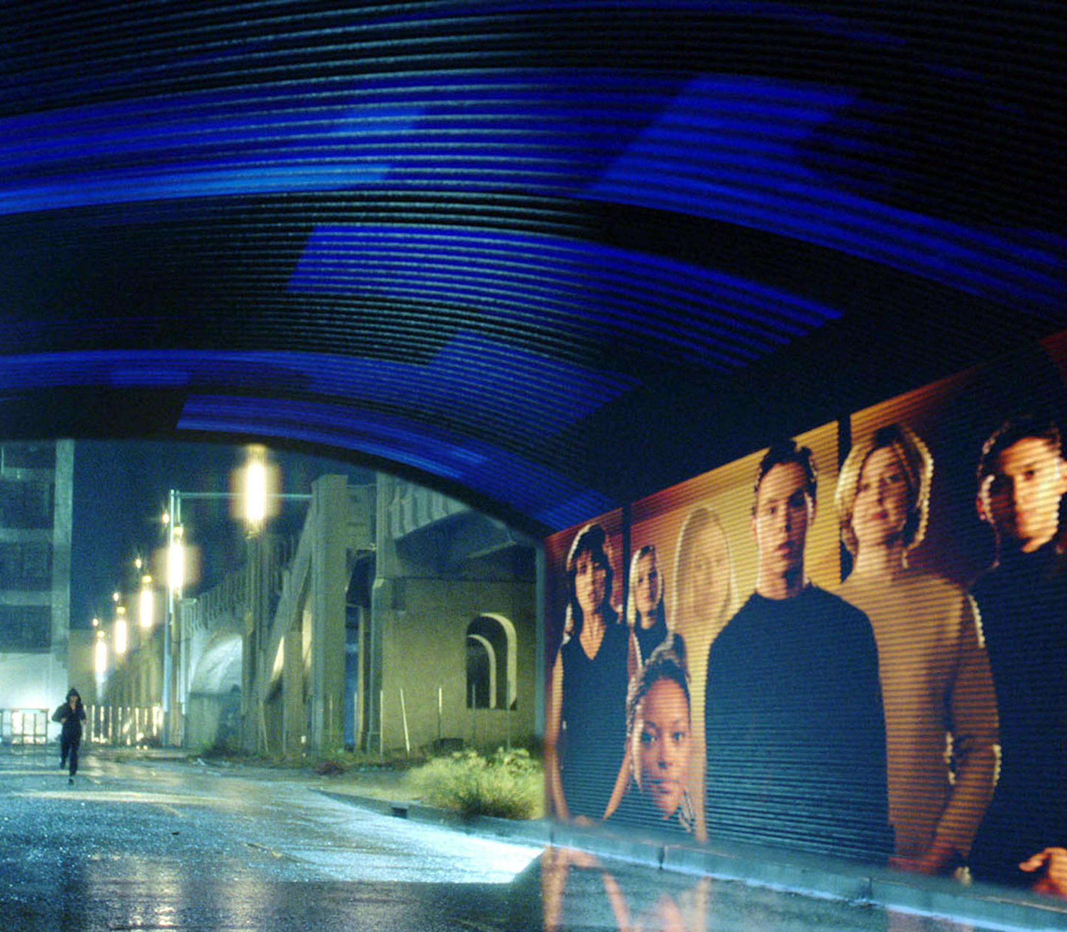 ** FOR RELEASE ANYTIME ** In this undated handout photo from Twentieth Century Fox, Tom Cruise runs a gantlet of electronic billboards that scan his retinas and hurl personalized pitches his way in a scene from Steven Spielberg's new movie "Minority Report." Many of the film's futuristic visions, including a holographic greeter at the Gap and animated cereal boxes, could become real using technology being developed today. (AP Photo/Twentieth Century Fox, David James)