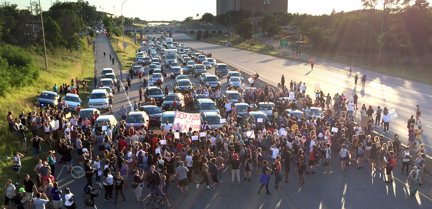 Marchers from the Black Lives Matter rally at the Minnesota Governor's Mansion, blocked off the interstate 94 eastbound lane near the Lexington Ave exit in St Paul Minnesota, July 9, 2016. [ Star Tribune photo by GLEN STUBBE ORG XMIT: MIN1607092025093007