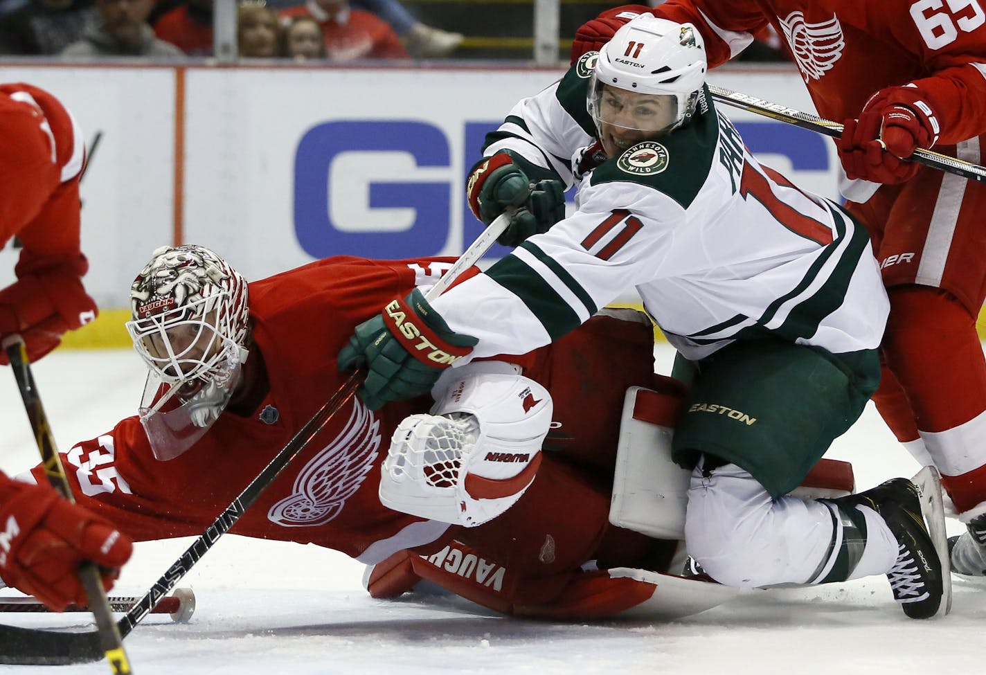 Minnesota Wild's Zach Parise (11) tries to take a shot on goal against Detroit Red Wings' Jimmy Howard (35) during the first period of an NHL hockey game Friday, April 1, 2016, in Detroit. (AP Photo/Duane Burleson)