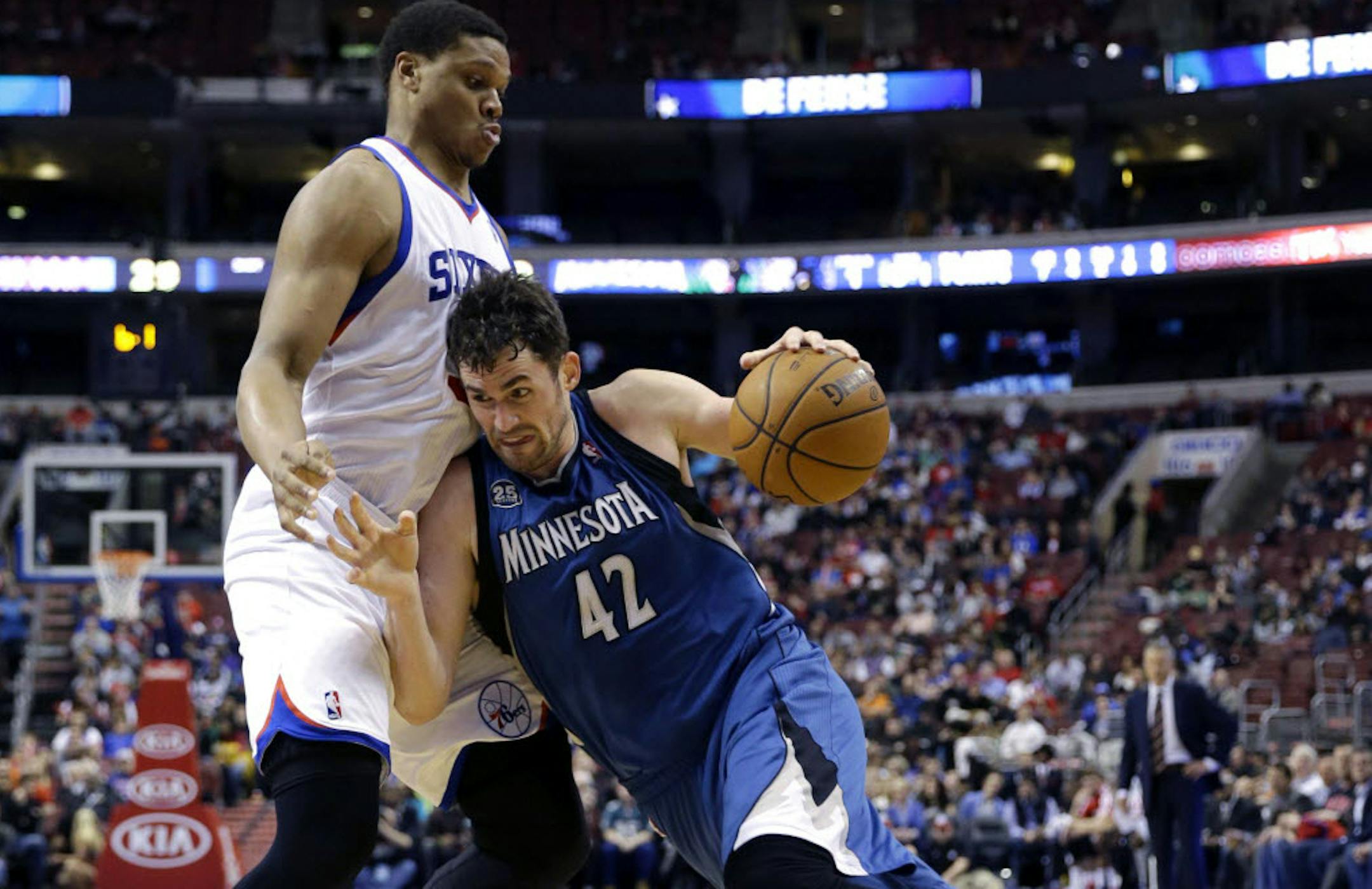 Kevin Love (42) tries to get past Philadelphia 76ers' Daniel Orton.