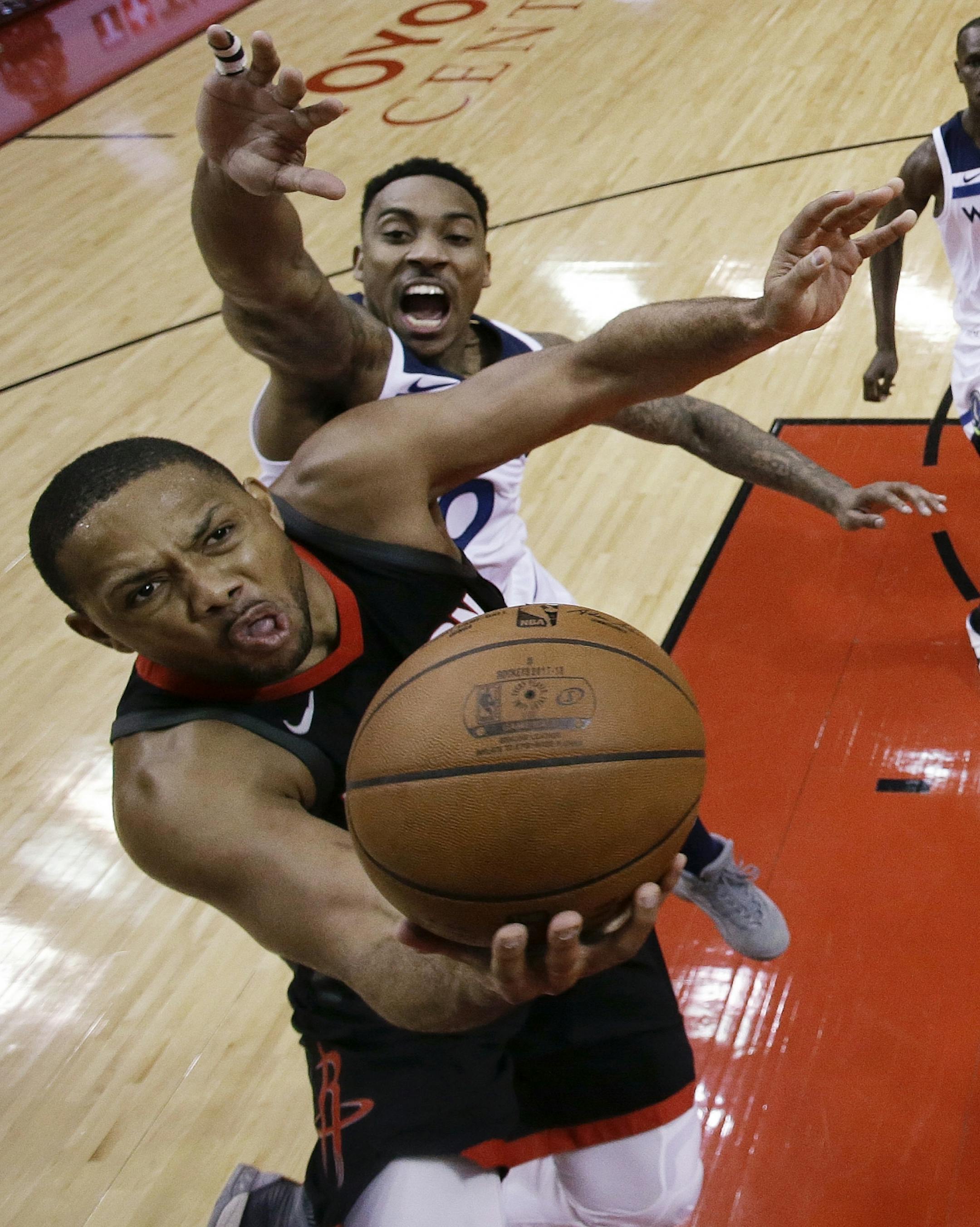 Houston Rockets guard Eric Gordon, bottom, drives to the basket as Minnesota Timberwolves guard Jeff Teague defends during the first half in Game 5 of a first-round NBA basketball playoff series Wednesday, April 25, 2018, in Houston.