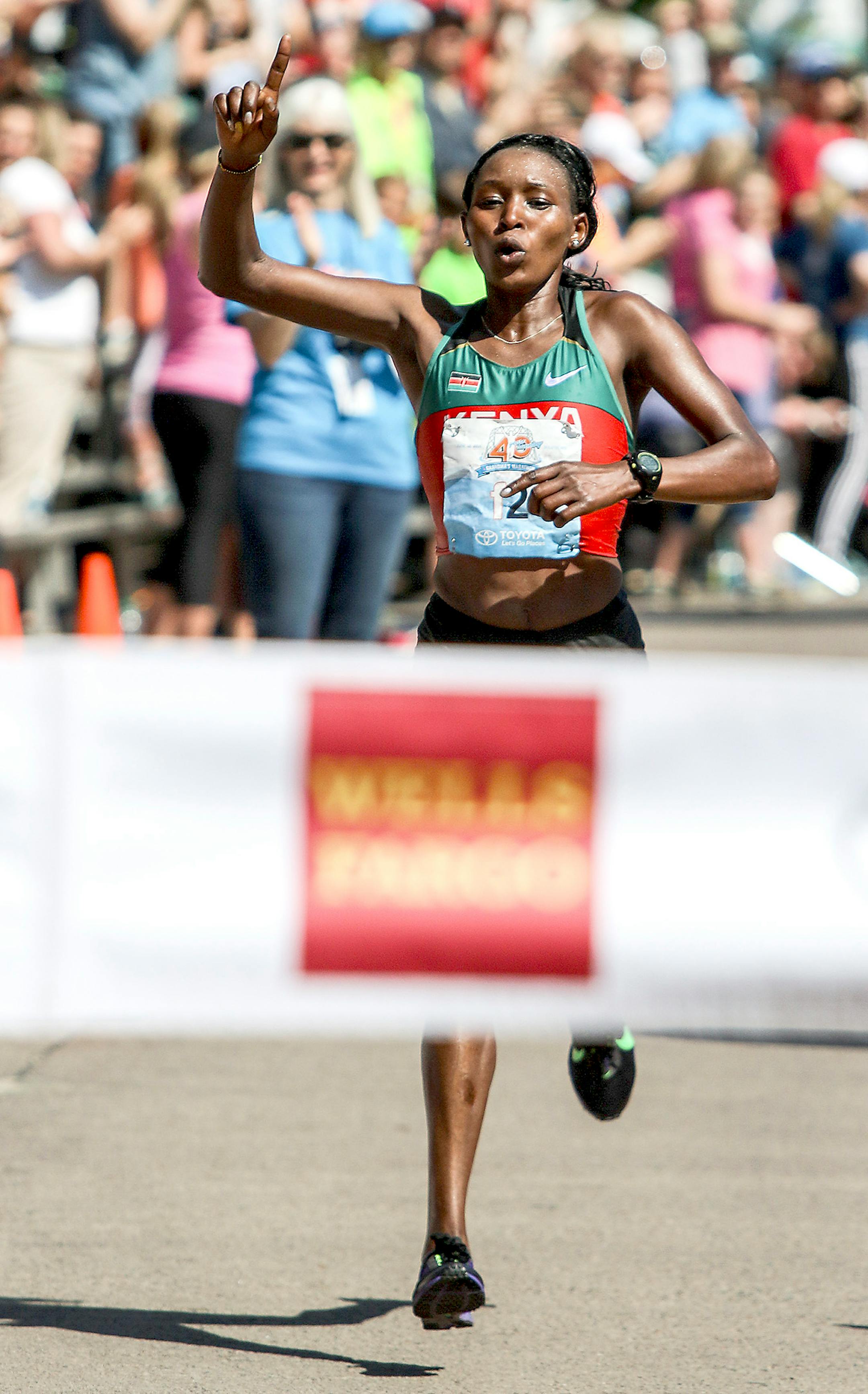 Sarah Kipto celebrates at the finish line of Grandma's Marathon in Duluth Saturday. Kipto won with a time of 2:33:29