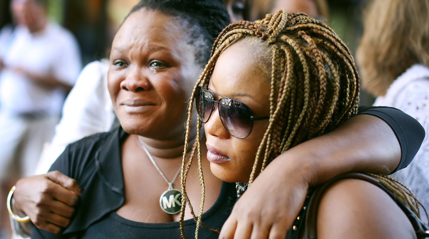 Barway Collins mother, Louis Karluah left and Yamah Collins (Barway's step mother) hugged each other after attending the court hearing at which Barway&#xed;s father, Pierre Collins, pleaded guilty to killing the 10-year-old boy Monday August 3, 2015 in Minneapolis, MN. ] Jerry Holt/ Jerry.Holt@Startribune.com