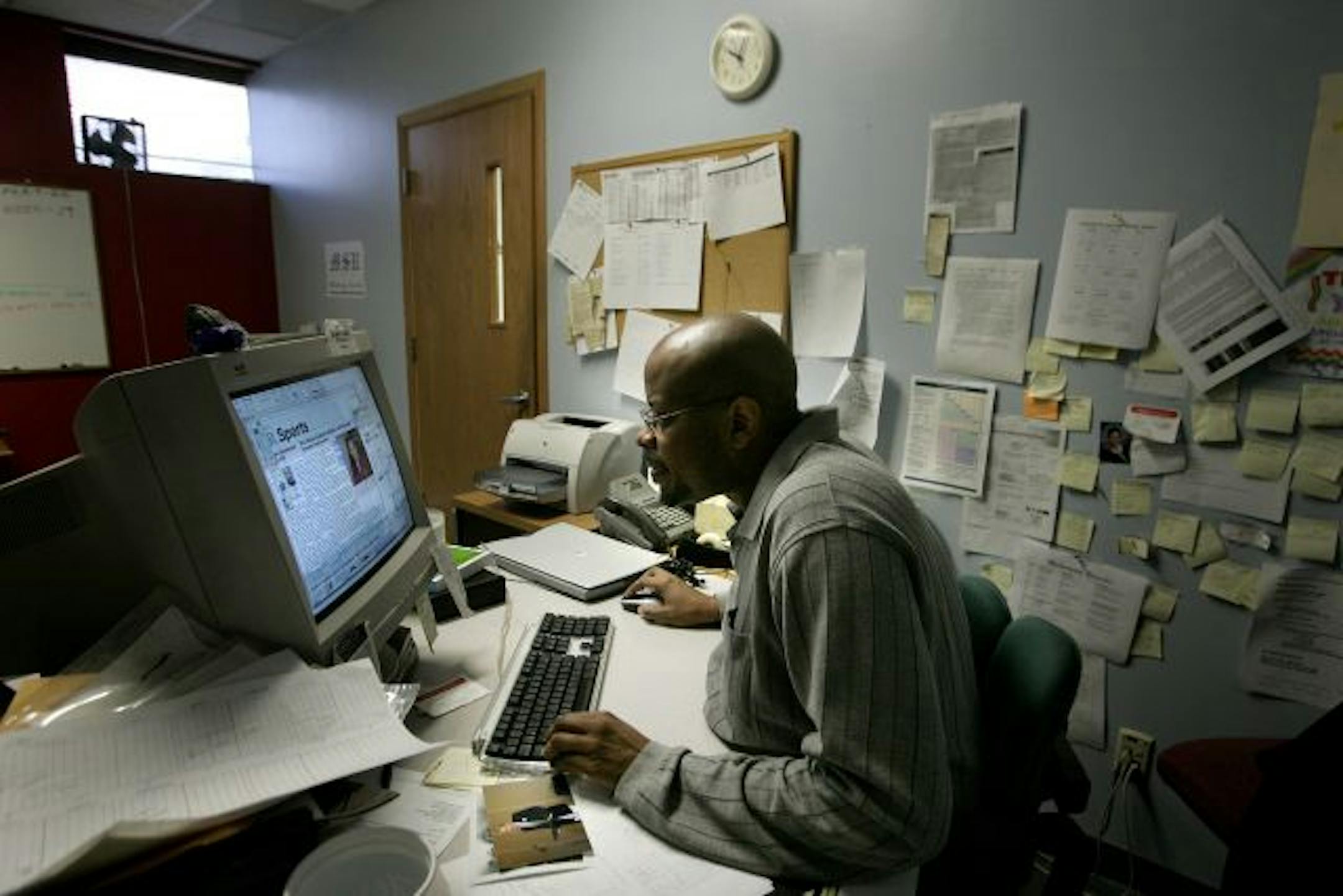 Minnesota Spokesman-Recorder graphic designer Christopher Harrison worked on a sports page.