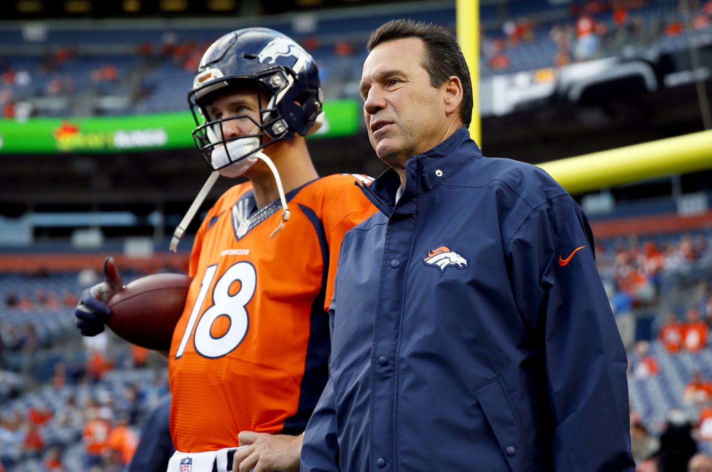 FILE - In this Sept. 3, 2015, file photo, Denver Broncos quarterback Peyton Manning (18) talks with head coach Gary Kubiak prior to an NFL preseason football game against the Arizona Cardinals in Denver. The Ravens enjoyed having Gary Kubiak on their side for one very productive season. There will be an awkward reunion Sunday when Baltimore opens the season against Kubiak's Denver Broncos. (AP Photo/Jack Dempsey, File) ORG XMIT: NY175