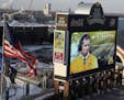 Newly named University of Minnesota football coach P.J. Fleck's image appeared on the score board at TCF Bank Stadium during a press conference Friday