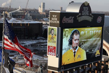 Newly named University of Minnesota football coach P.J. Fleck's image appeared on the score board at TCF Bank Stadium during a press conference Friday