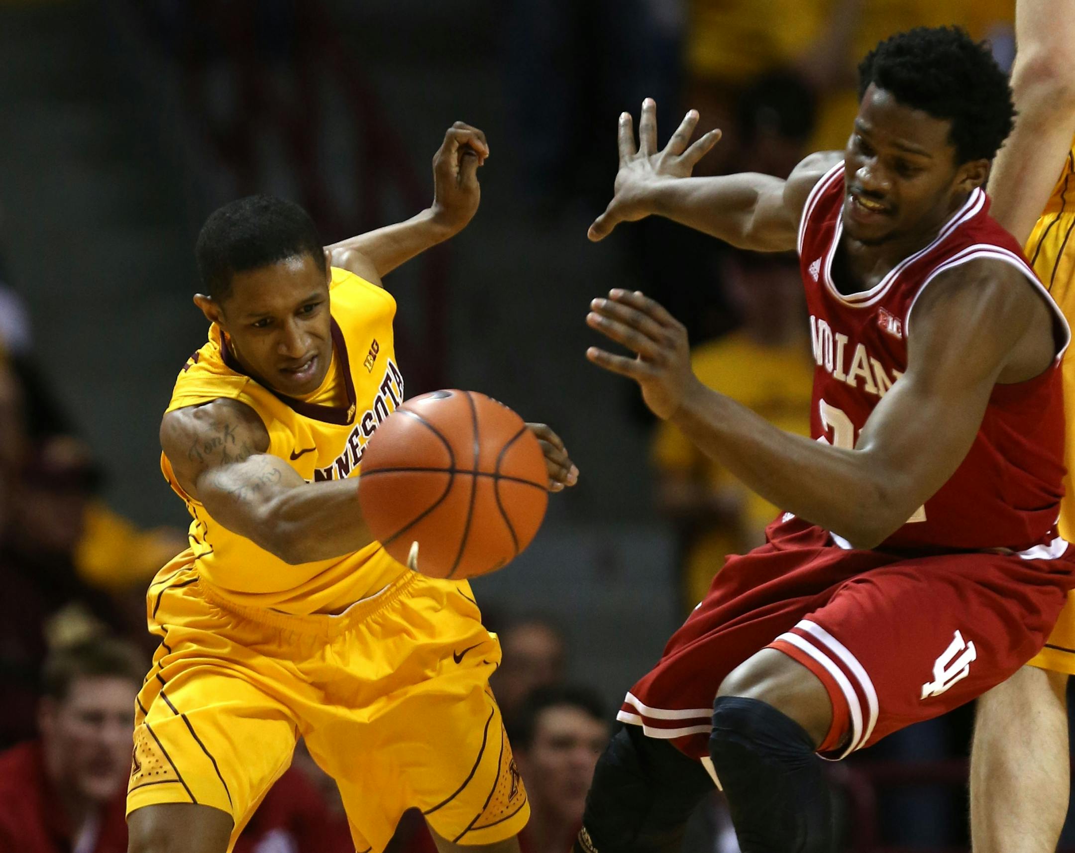 Gophers point guard DeAndre Mathieu and Indiana's Stanford Robinson went after a loose ball during the first half at Williams Arena on Saturday.