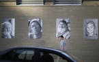 A man walked past portrait photographs that are displayed outside St. Paul's CHS Field in Lowertown as part of the Inside Out project in St. Paul, Min