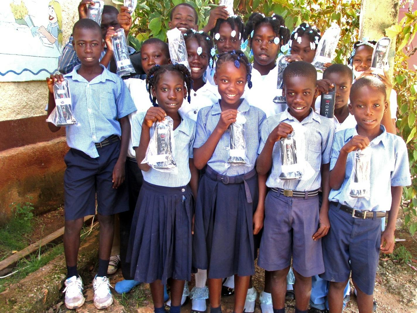 More than 2,000 families and students in Haiti, shown here, and the Dominican Republic, who lack electricity, have received solar-powered XTorches thanks to Gene and Keidy Palusky of Edina, working through nonprofit partners Compassion International and Bethany Christian Services. Photo: Compassion International