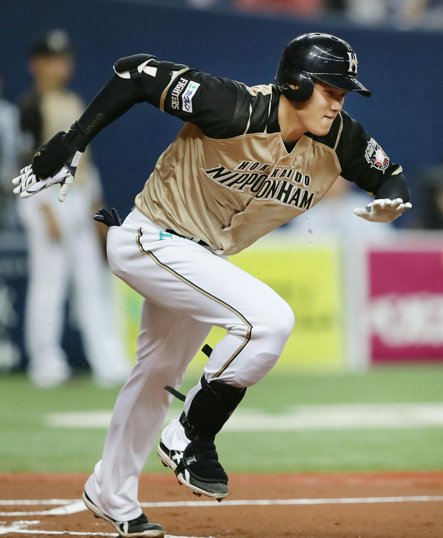 In this Saturday, April 8, 2017 photo, Japanese baseball player Shohei Otani of the Nippon Ham Fighters dashes to the first base after hitting a third base grounder in the first inning of a game against the Orix BlueWave in Osaka, western Japan. Otani will be sidelined for about six weeks because of a left-thigh muscle strain, his team said on Sunday. Otani, who is expected to move to Major League Baseball in 2018, hurt his left leg trying to beat out a infield single in the Fighters' loss to th