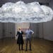 Caitlind r.c. Brown and Wayne Garrett beneath their "Cloud," made up of thousands of bulbs that viewers can illuminate by pulling the cords.