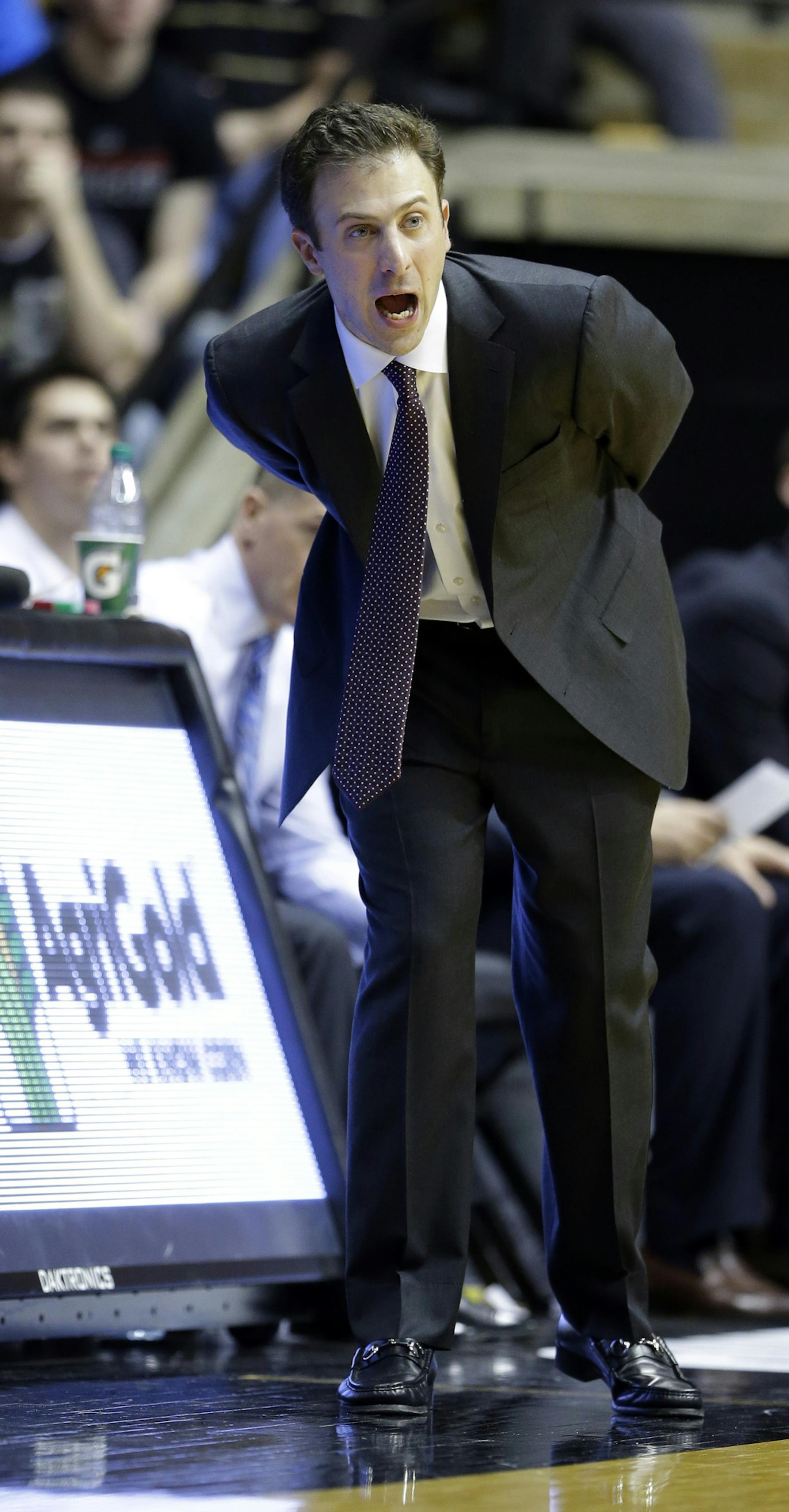 Minnesota head coach Richard Pitino yells to his team as they played Purdue in the second half of an NCAA college basketball game in West Lafayette, Ind., Wednesday, Dec. 31, 2014. Purdue defeated Minnesota 72-68. (AP Photo/Michael Conroy)